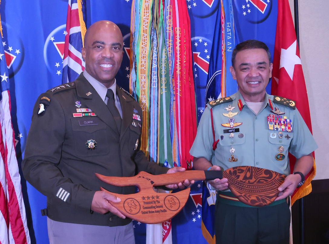 U.S. Army Gen. Ronald Clark (left), Commanding General of USARPAC, and Gen. Muhammad Hafizuddeain (right), Chief of Malaysian Army, participate in a gift exchange during the 2025 Land Forces Pacific Symposium and Exposition (LANPAC), Honolulu, Hawaii, May 14, 2025.