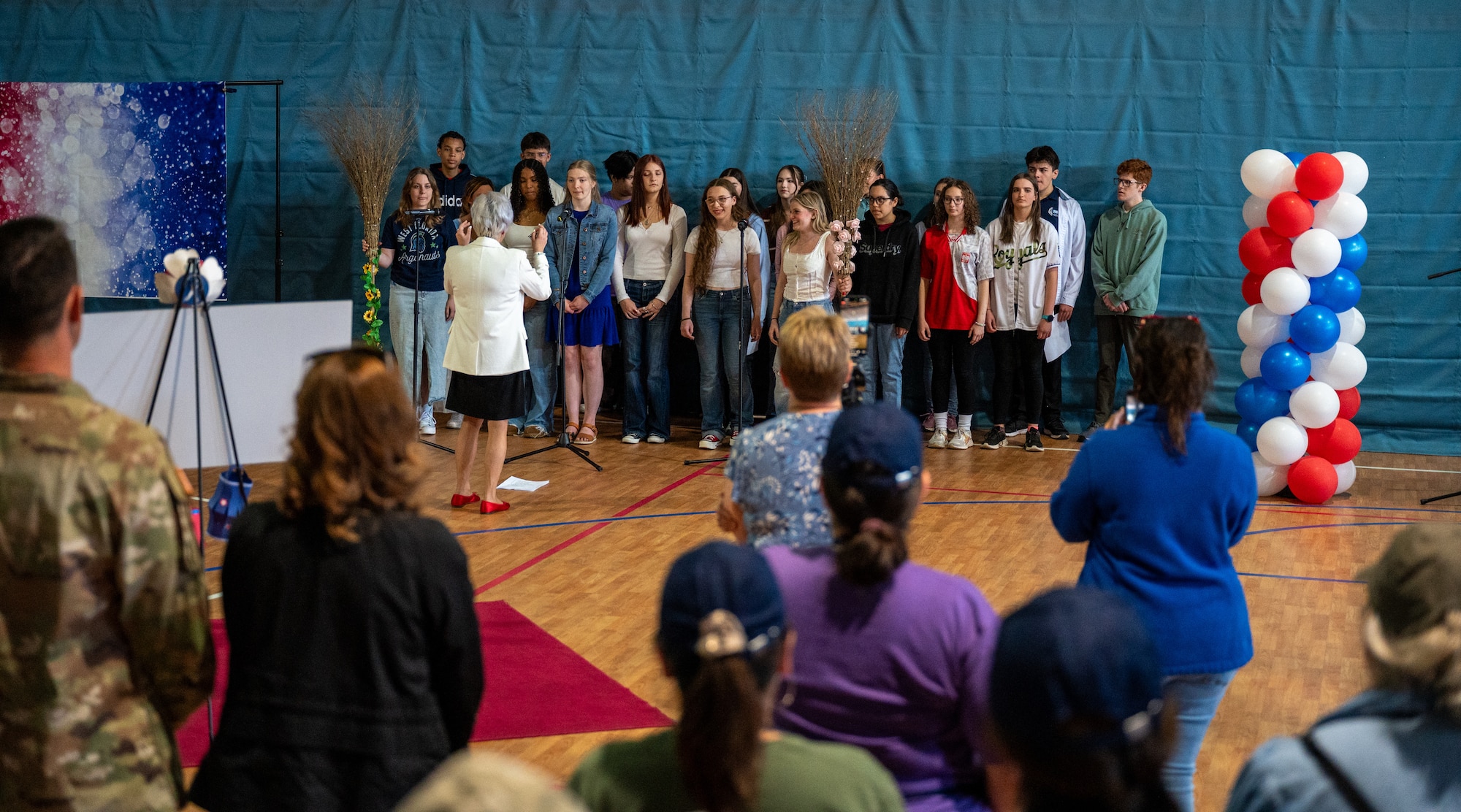 The Ramstein High School choir sings during the fifth annual Military Spouse Appreciation Day event at Ramstein Air Base, Germany, May 9, 2025. The event brought the Kaiserslautern Military Community together to celebrate and show appreciation for military spouses. (U.S. Air Force photo by Senior Airman Jared Lovett)