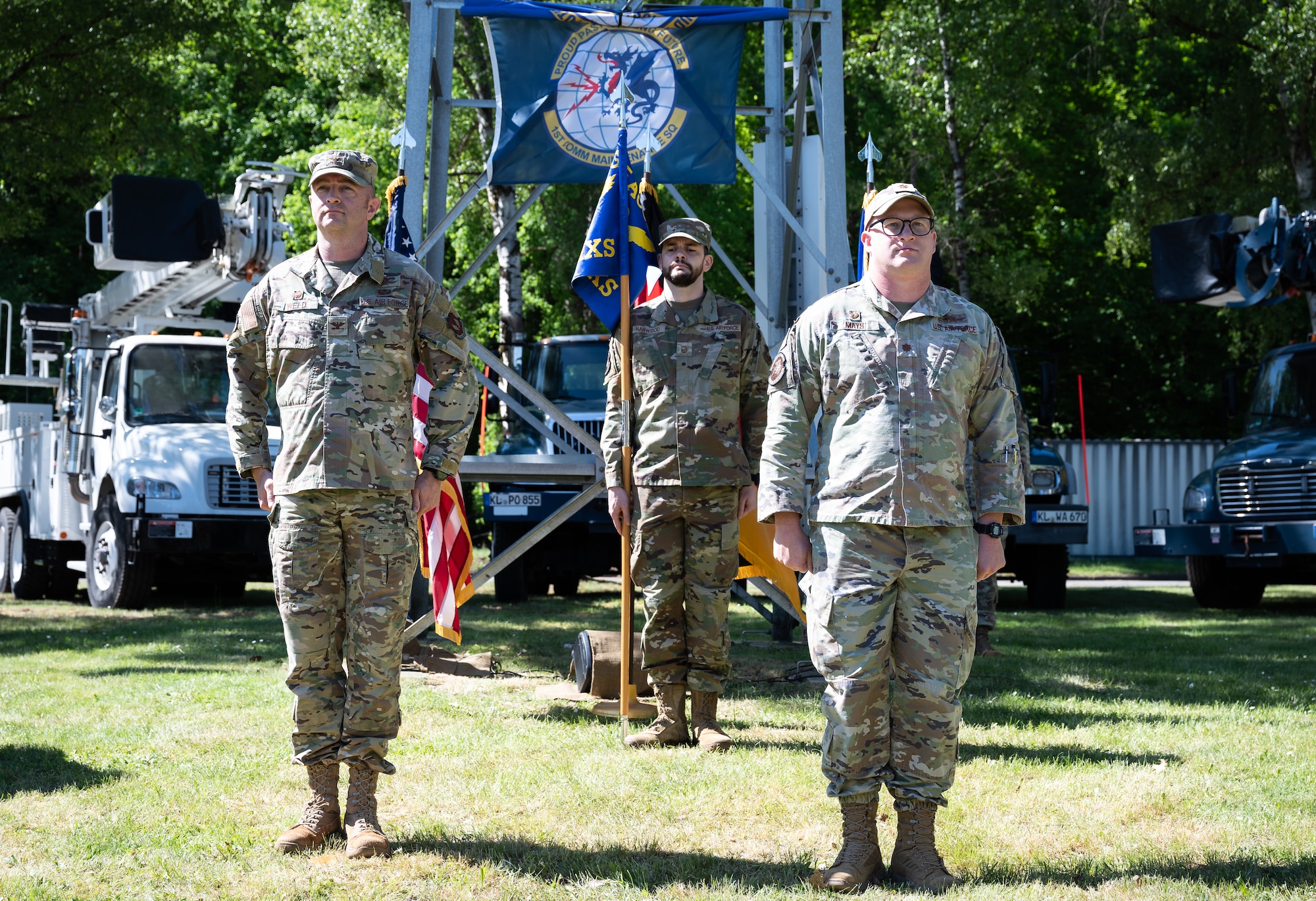 U.S. Air Force Col. Scott Weed, 435th Communications Operations Group commander, and Maj. Caleb Mays, 1st Communication Maintenance Squadron commander, prepare to re-designate the 1st CMXS to the 1st Engineering Installation Squadron during a redesignation ceremony at Kapaun Air Station, Germany, May 12, 2025. The redesignation marks a pivotal shift for the unit, establishing a formal process for them to accomplish communications support across all of United States Air Forces in Europe – Air Forces Africa. (U.S. Air Force photo by Senior Airman Jared Lovett)