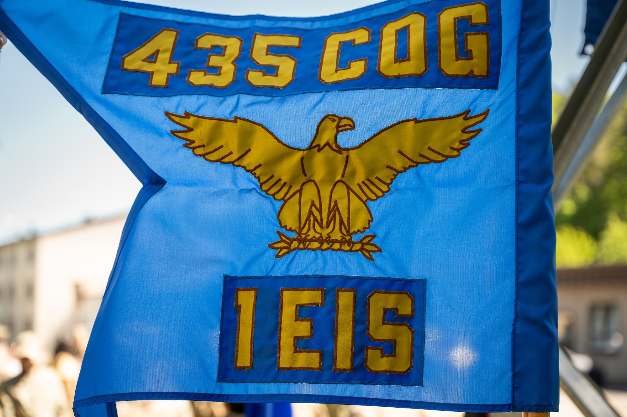 The 1st Engineering Installation Squadron guidon sways during a redesignation ceremony at Kapaun Air Station, Germany, May 12, 2025. The redesignation marks a pivotal shift for the unit, establishing a formal process for them to accomplish communications support across all of United States Air Forces in Europe – Air Forces Africa. (U.S. Air Force photo by Senior Airman Jared Lovett)