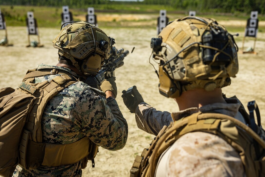 U.S. Marine Corps Lance Cpl. Diego Vasquez, left, an infantry rifleman with 2d Battalion, 6th Marine Regiment, 2d Marine Division, fires at a target with an M27 Infantry Automatic Rifle during a live-fire range as part of a Tactical Small Unit Leadership Course on Marine Corps Base Camp Lejeune, North Carolina, May 6, 2025. 2/6 participated in TSULC to provide small unit leaders the opportunity to enhance their knowledge, confidence and proficiency to lead Marines in combat scenarios. (U.S. Marine Corps photo by Lance Cpl. Judith Ann Lazaro)