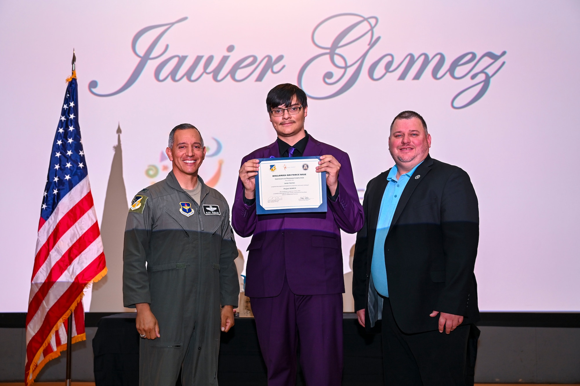 Javier Gomez, Project SEARCH intern, accepts a graduation certificate at Holloman Air Force Base, New Mexico, May 13, 2025. Project SEARCH is a high school transition program that provides training and education leading to employment for students with developmental disabilities. (U.S. Air Force photo by Senior Airman Michelle Ferrari)