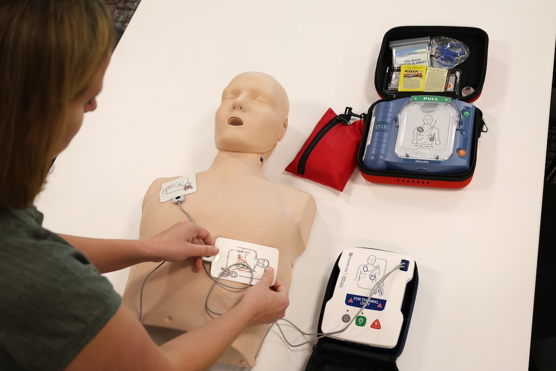 Alicia Hodge, Huntsville Center Safety and Occupational Health specialist, demonstrates using an AED on a Prestan Manikin with the Prestan AED UltraTrainer.