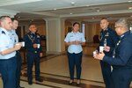 Counterparts from the Royal Thai Air Force and U.S. Air Force socialize over a cup of coffee during an Airman-to-Airman Talks in Pattaya, Thailand, May 13, 2025.
