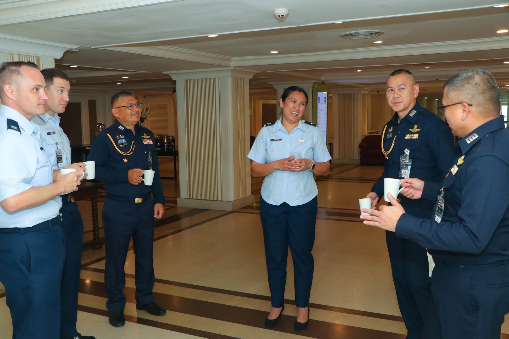 Counterparts from the Royal Thai Air Force and U.S. Air Force socialize over a cup of coffee during an Airman-to-Airman Talks in Pattaya, Thailand, May 13, 2025.