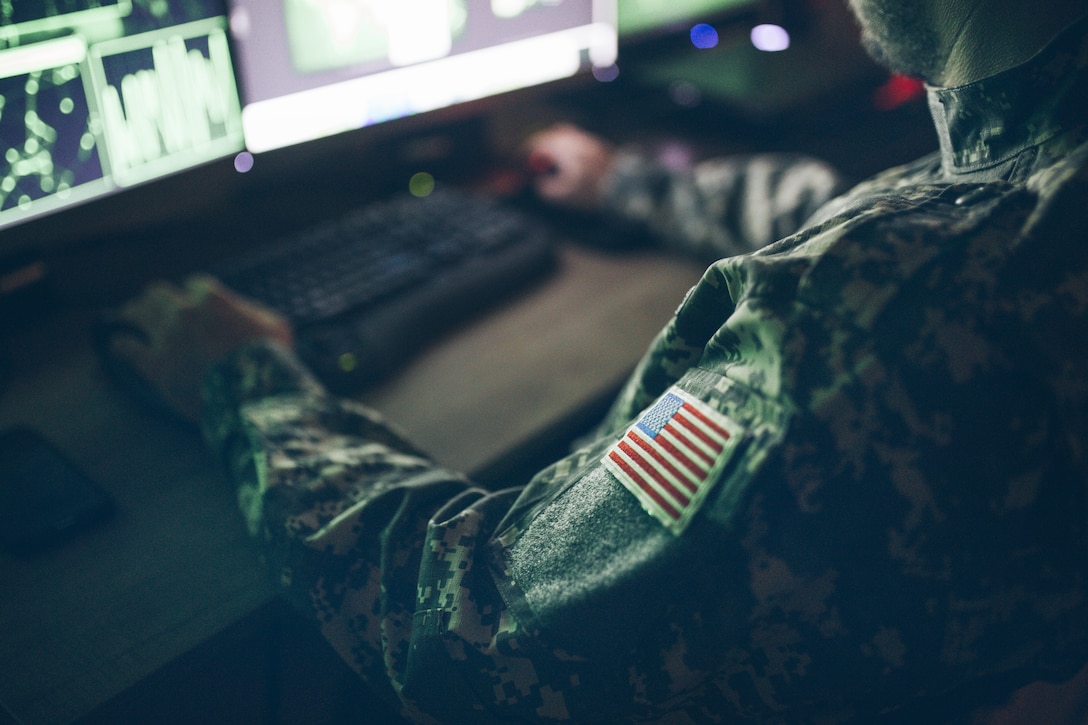 American soldier sitting at a computer