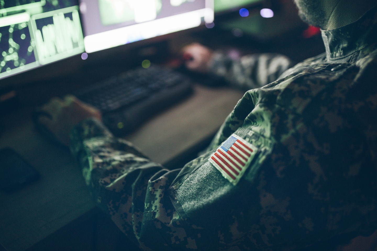 American soldier sitting at a computer