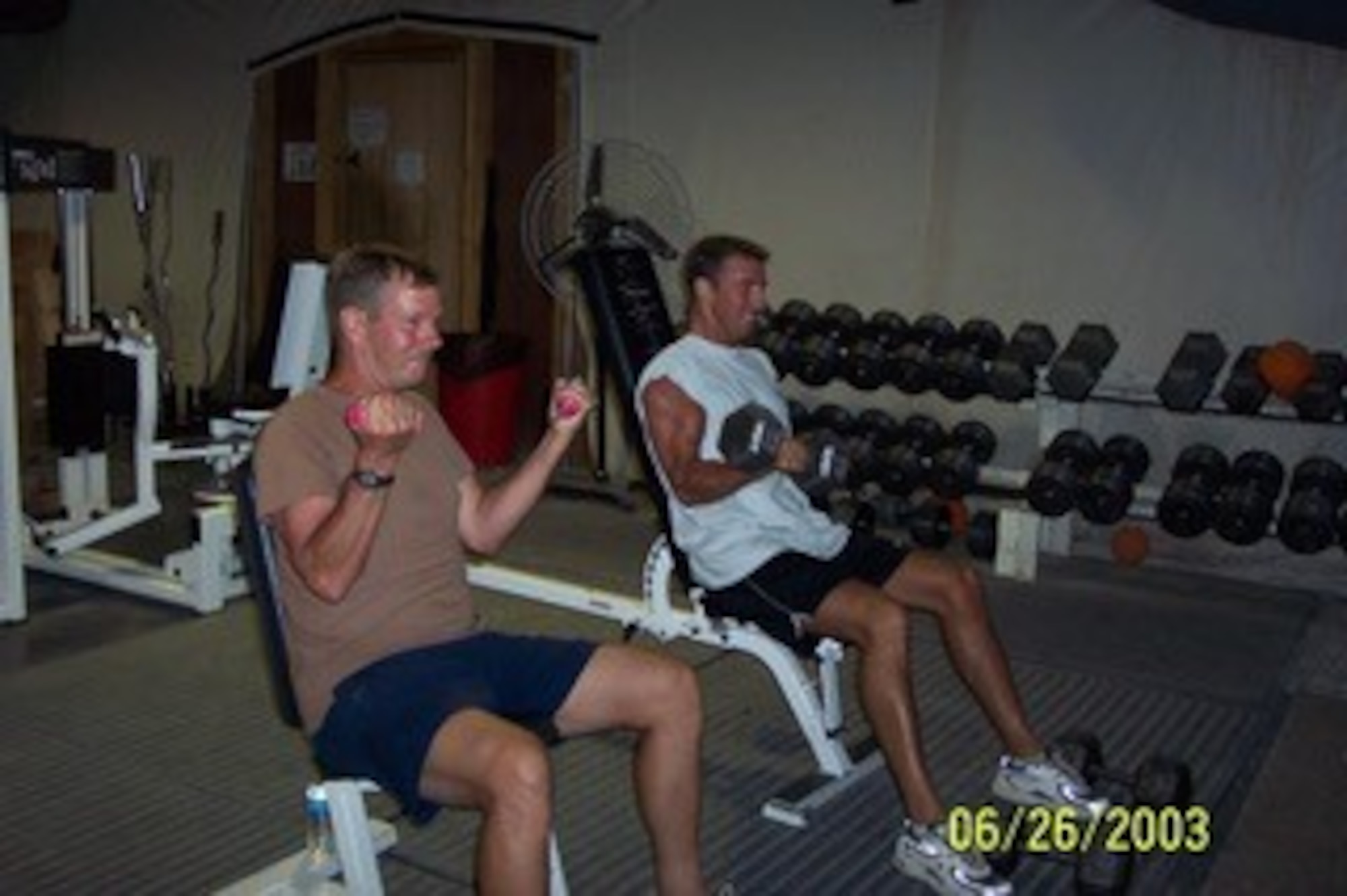 1st Lt CJ Pfeil (right) works out with his father, SMSgt Christopher Pfeil during a Operation Iraqi Freedom in 2003. In between flying sorties, the duo helped build up the base in Saudi Arabia.