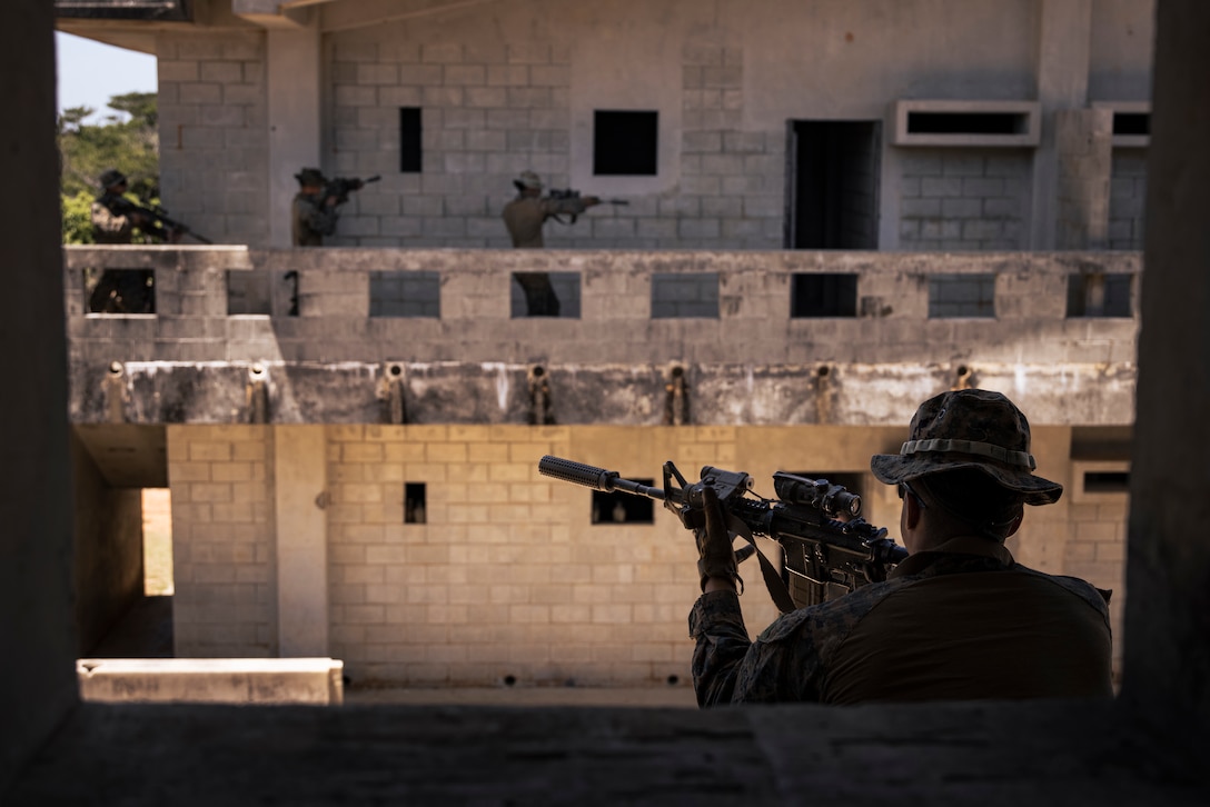 U.S. Marine Corps Cpl. Sidney A. Sotelomadera, an infantry Marine with Charlie Company, Battalion Landing Team 1st Battalion, 7th Marine Regiment, 31st Marine Expeditionary Unit, provides overwatch security with an M4 carbine during a simulated force-on-force mechanized raid at Combat Town, Camp Hansen, Okinawa, Japan, April 24, 2025. The purpose of the exercise was to create a challenging, realistic training environment with the integration of the newly fielded Amphibious Combat Vehicle that produces combat-ready forces in urban terrain.  (U.S. Marine Corps photo by Cpl. Angel Diaz Montes De Oca)
