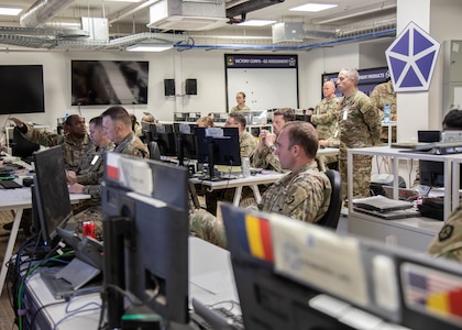 U.S. Army Soldiers representing different staff sections within V Corps review intelligence reports as Col. Kevin Jackson, V Corps Chief of Staff, left, briefs strategies and operations May 13, 2025, at Camp Kościuszko, Poland. The primary mission of V Corps is to conduct operational planning, mission command, and oversight of rotational forces in Europe. It also provides additional capabilities in support of allies and partners in the region, such as deterring aggression on NATO’s Eastern Flank. (U.S. Army photo by Sgt. Devin Klecan)