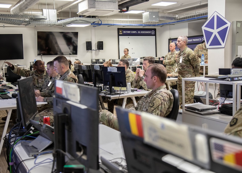 U.S. Army Soldiers representing different staff sections within V Corps review intelligence reports as Col. Kevin Jackson, V Corps Chief of Staff, left, briefs strategies and operations May 13, 2025, at Camp Kościuszko, Poland. The primary mission of V Corps is to conduct operational planning, mission command, and oversight of rotational forces in Europe. It also provides additional capabilities in support of allies and partners in the region, such as deterring aggression on NATO’s Eastern Flank. (U.S. Army photo by Sgt. Devin Klecan)