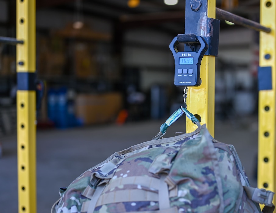 A scale weighs a rucksack at 36.93 lbs after the Norwegian Foot March at the 17th Security Forces Squadron warehouse during the 2025 annual Goodfellow Norwegian Foot March, Goodfellow Air Force Base, Texas, on May 3, 2025. Originating in 1915 as an endurance test for Norwegian armed forces, the 18.6-mile march allows participants to test their cardiovascular endurance and build esprit de corps. (U.S. Air Force photo by Senior Airman Evelyn J. D’Errico)