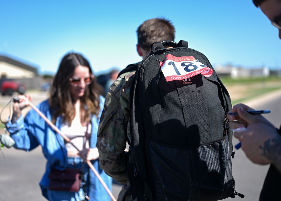Senior Airman Zachary Heimbauch, 17th Training Wing public affairs journeyman, walks to see his wife, Tina, at the finish line at the 17th Security Forces Squadron warehouse during the 2025 Goodfellow Norwegian Foot March, Goodfellow Air Force Base, Texas, May 3, 2025. This event was open to the public, welcoming civilians and service members from all military branches to compete and offering active-duty participants the opportunity to qualify for the Norwegian Foot March badge. (U.S. Air Force photo by Senior Airman Evelyn J. D’Errico)
