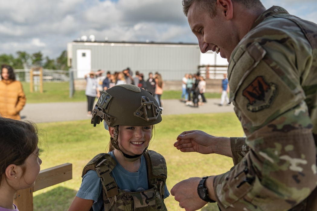 A student tries on a vest.