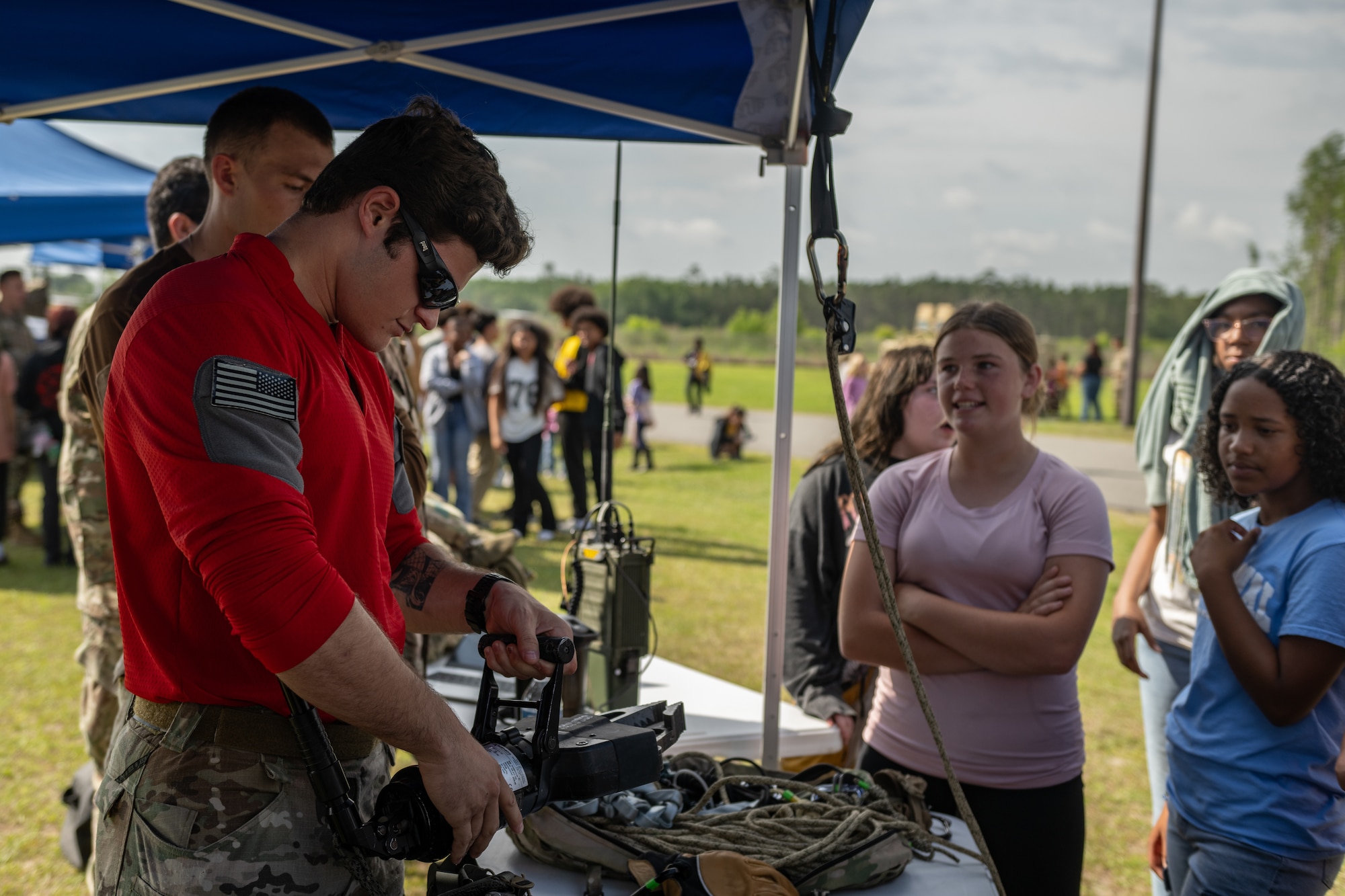 A PJ shows a student a piece of equipment.