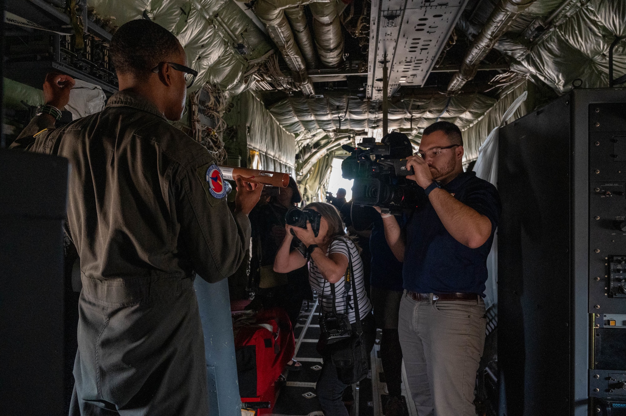 Airman being interviewed on camera by media.