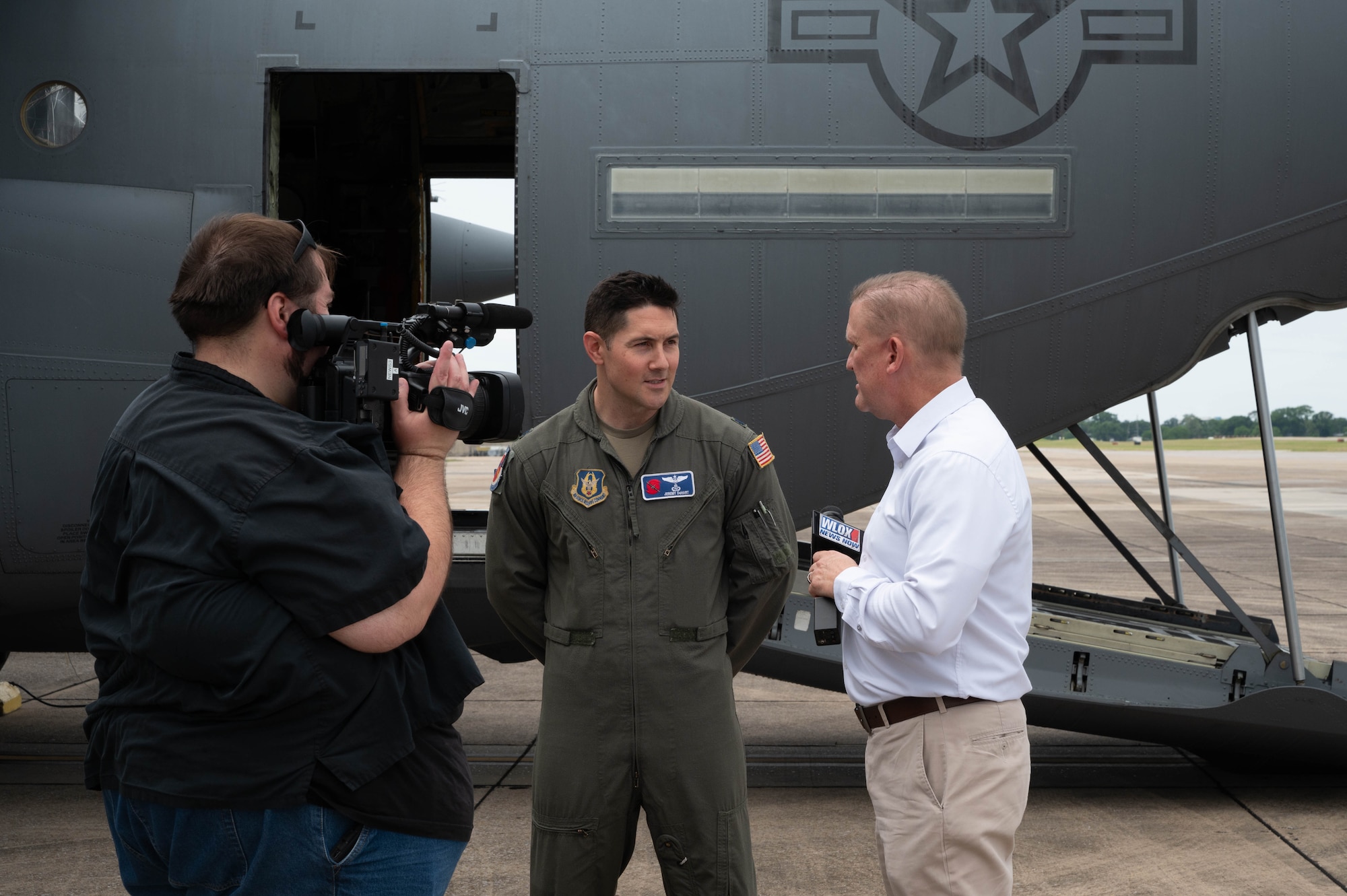 Airman being interviewed on camera by media.