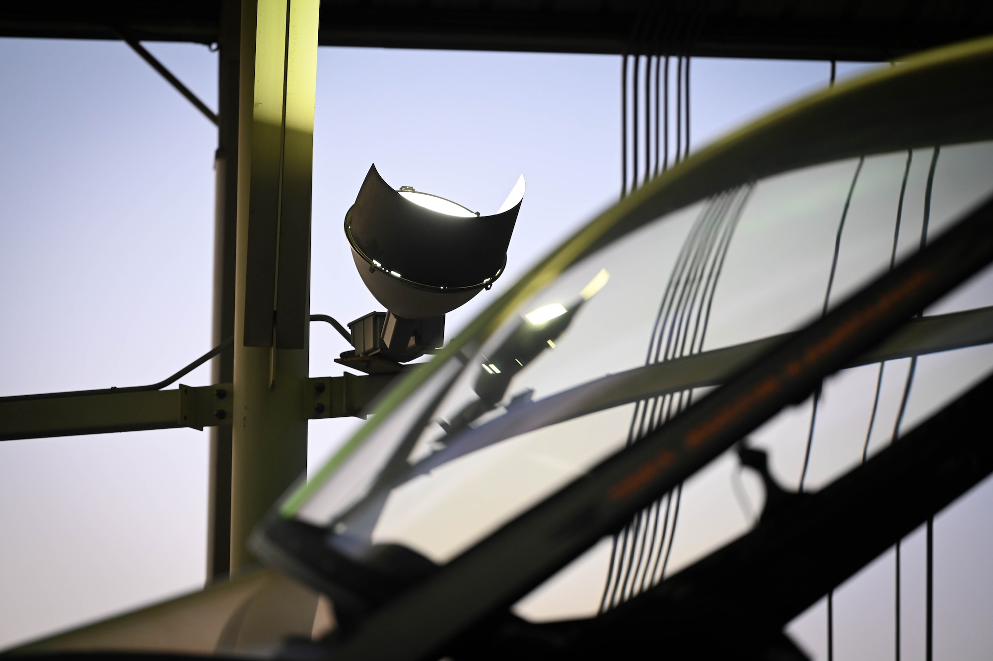 A sun shade light illuminates a U.S. Air Force F-16C Fighting Falcon at Shaw Air Force Base, S.C., Dec. 12, 2024. Upgraded lighting equipment greatly improves visibility for maintenance personnel at night, increasing mission effectiveness and safety. (U.S. Air Force photo by Senior Airman Steven Cardo)