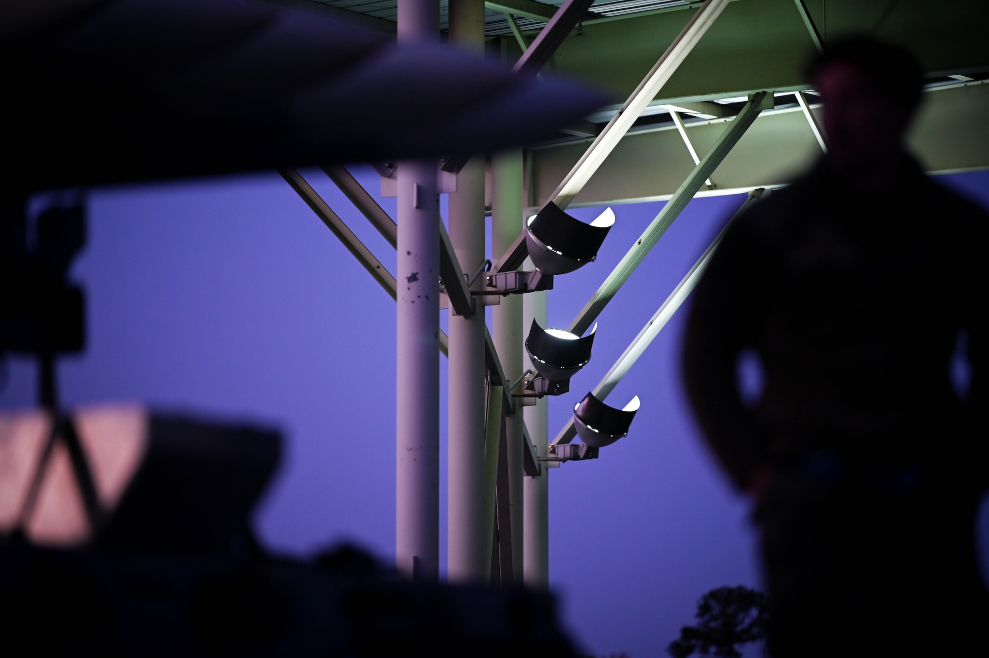 Sun shade lights provide light for maintenance personnel at night at Shaw Air Force Base, S.C., Dec. 12, 2024. The upgraded LED lighting equipment offers increased visibility for personnel operating at night and increases electrical efficiency to lower cost of use for the installation. (U.S. Air Force photo by Senior Airman Steven Cardo)