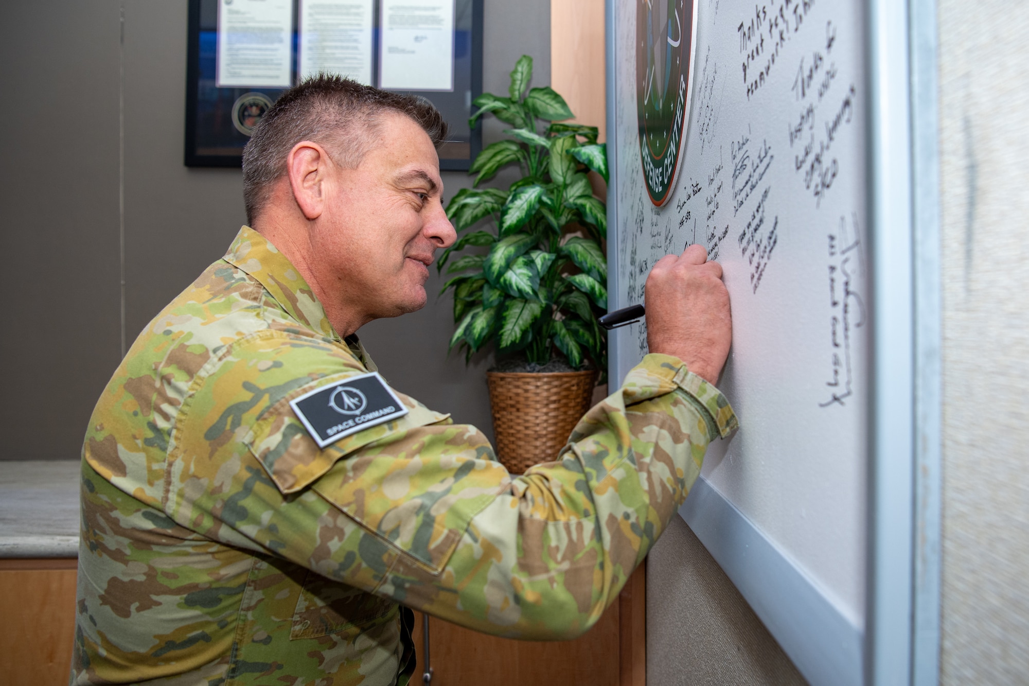 Man in uniform signs board