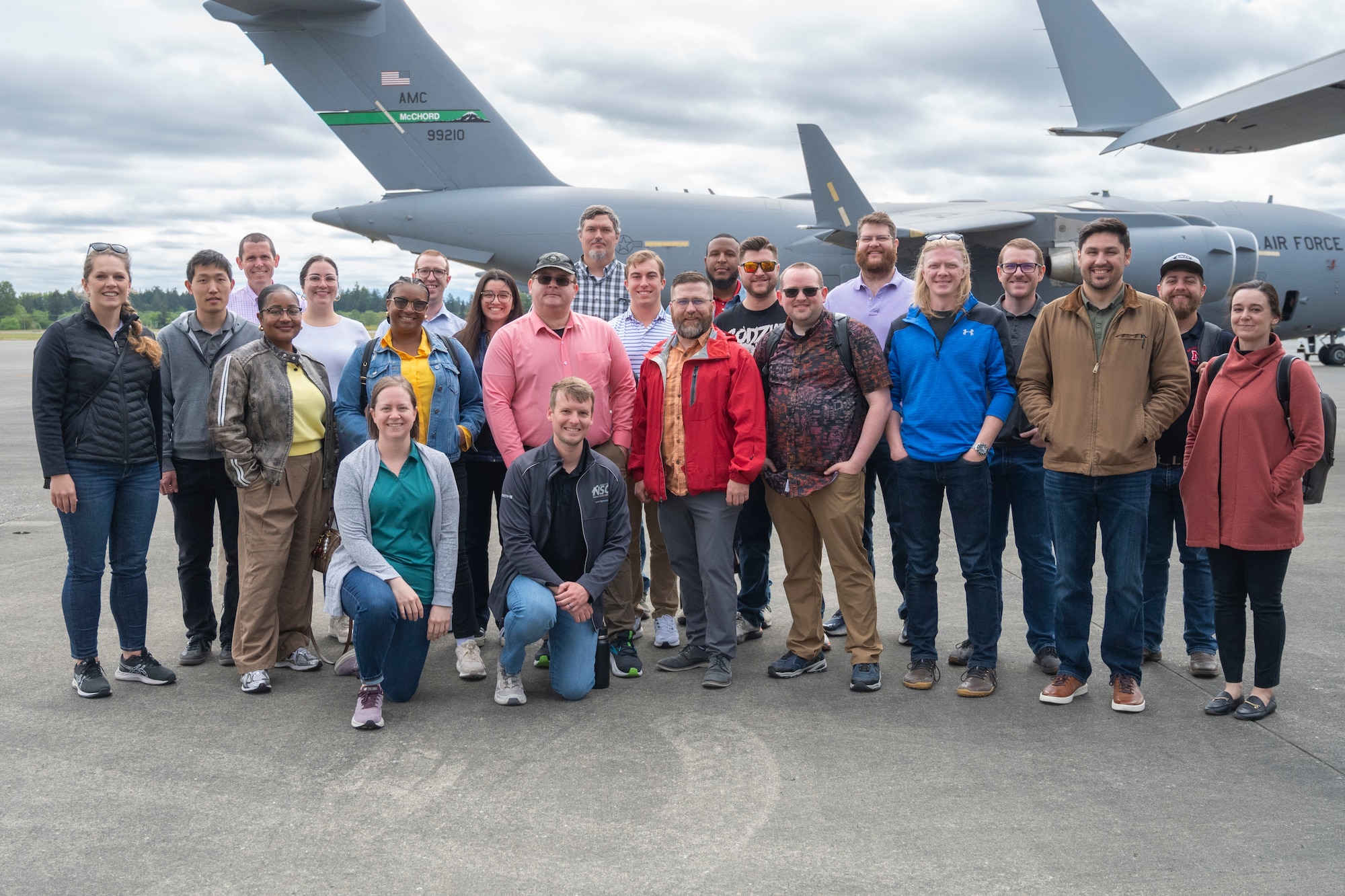 Sandia National Laboratories Weapon Intern Program participants stand together on the McChord flightline at Joint Base Lewis-McChord, Washington, May 7, 2025.