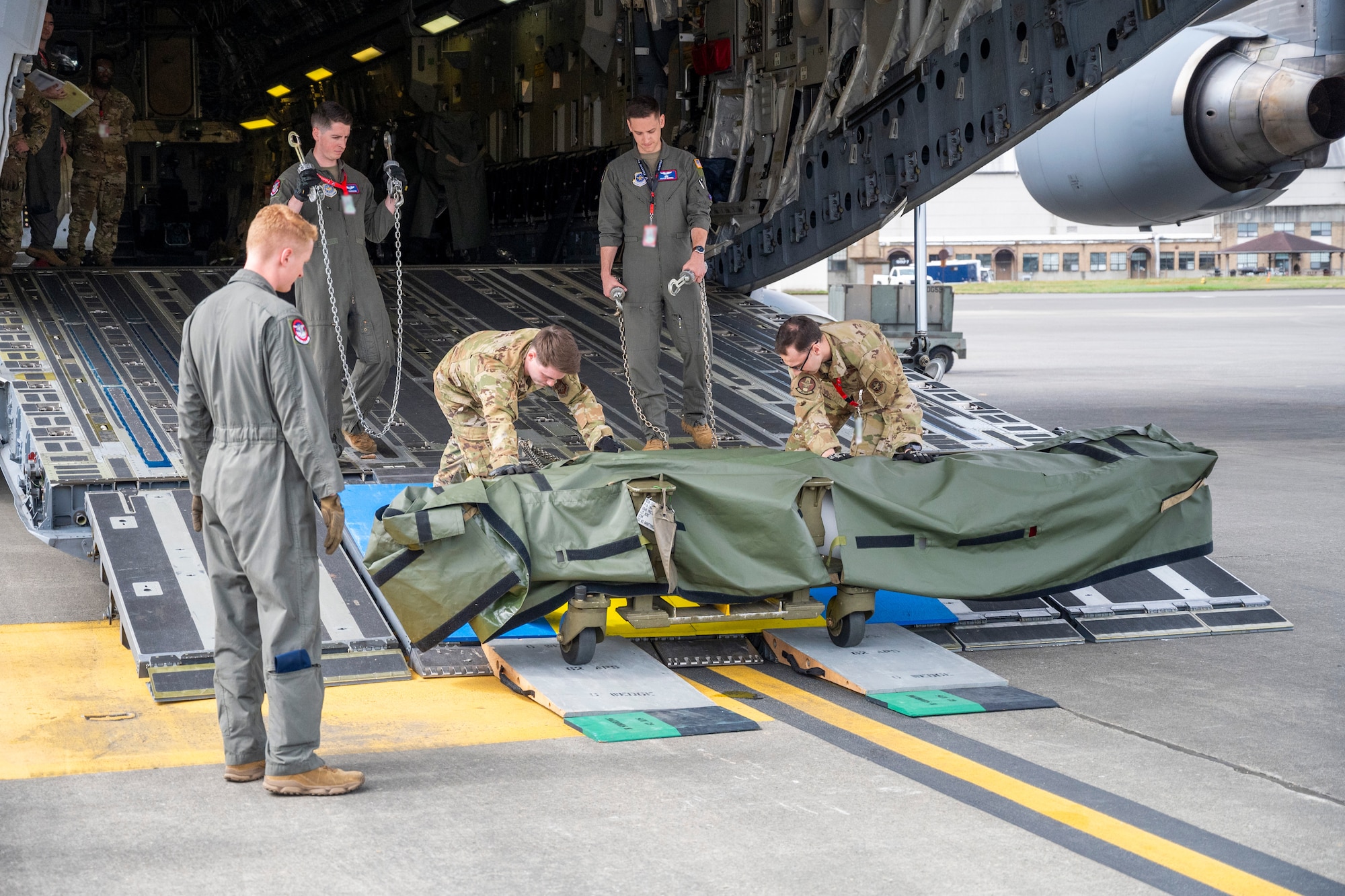 U.S. Air Force Airmen with the 62d Airlift Wing conduct critical training during the Sandia National Laboratories Weapon Intern Program C-17 Globemaster III tour at Joint Base Lewis-McChord, Washington, May 7, 2025.