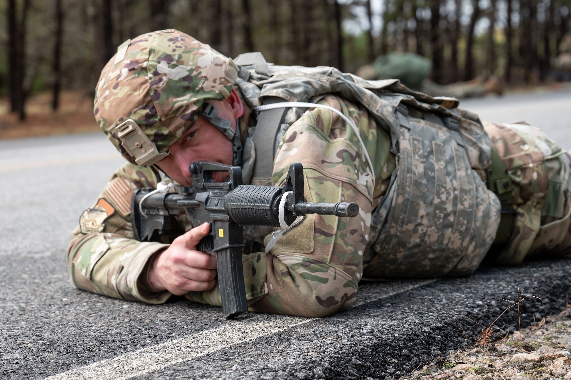 Airman assumes prone position during a ruck march.