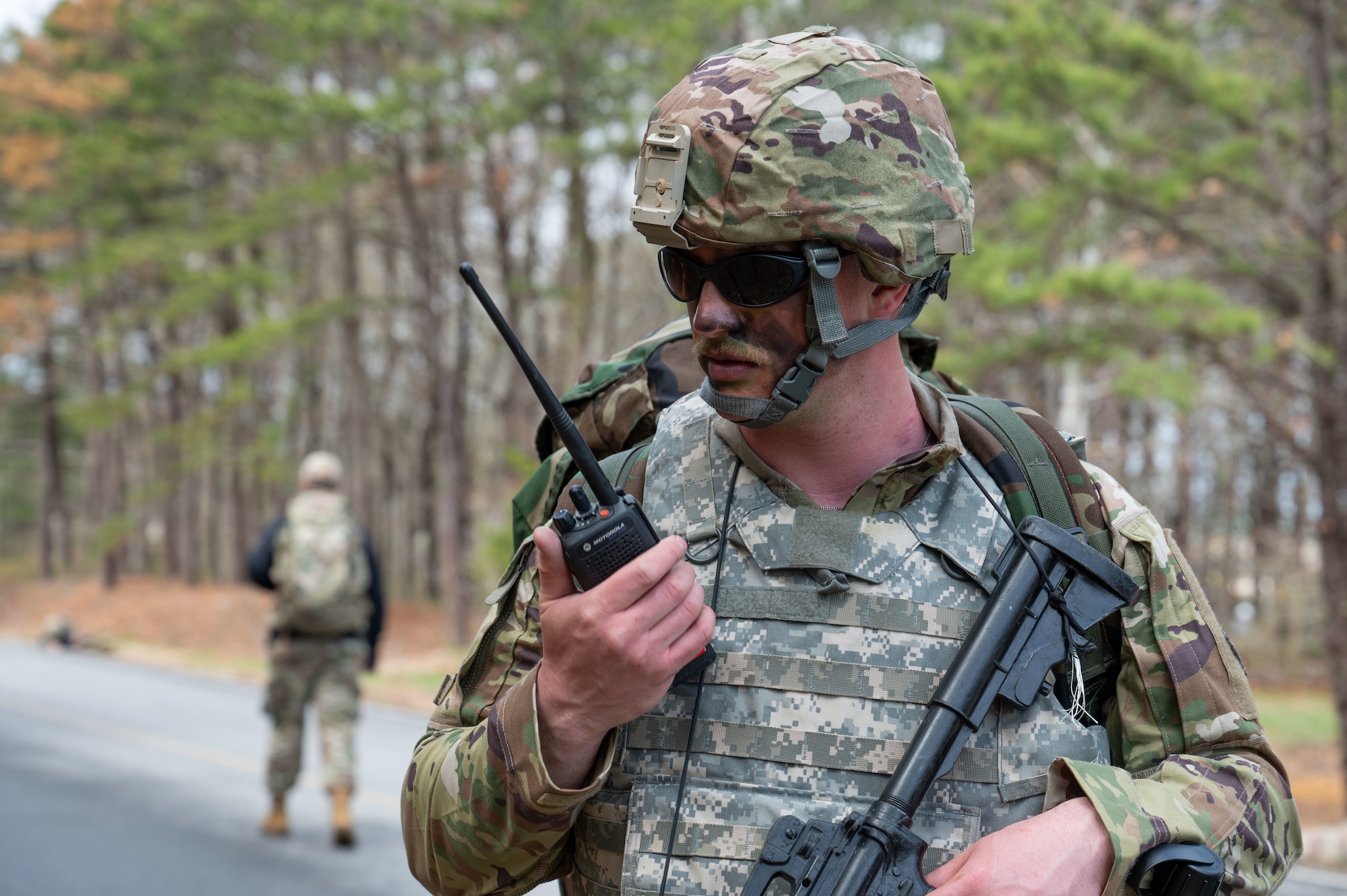 Airman speaks into a radio.