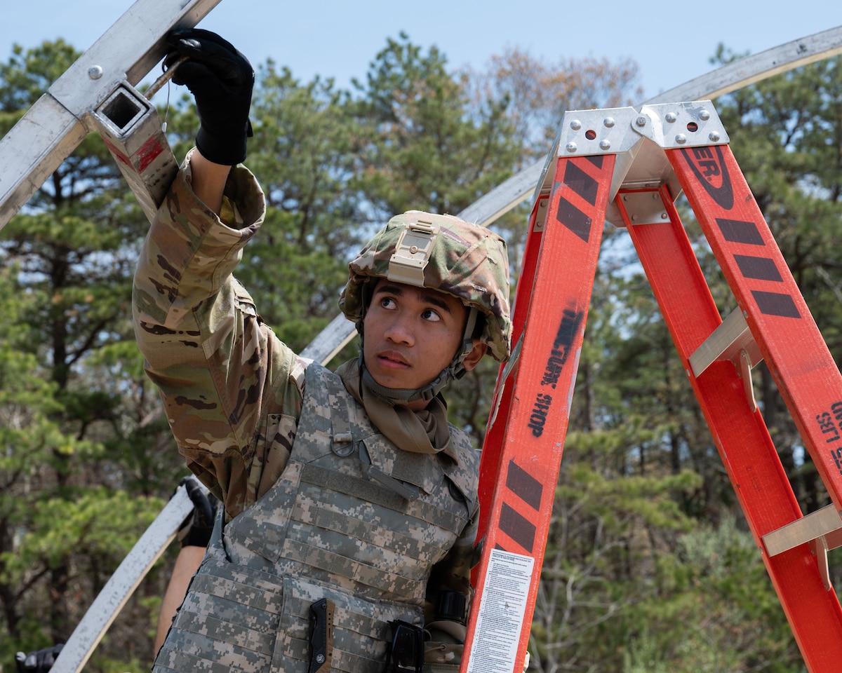 Airman puts a pin in a temper tent.
