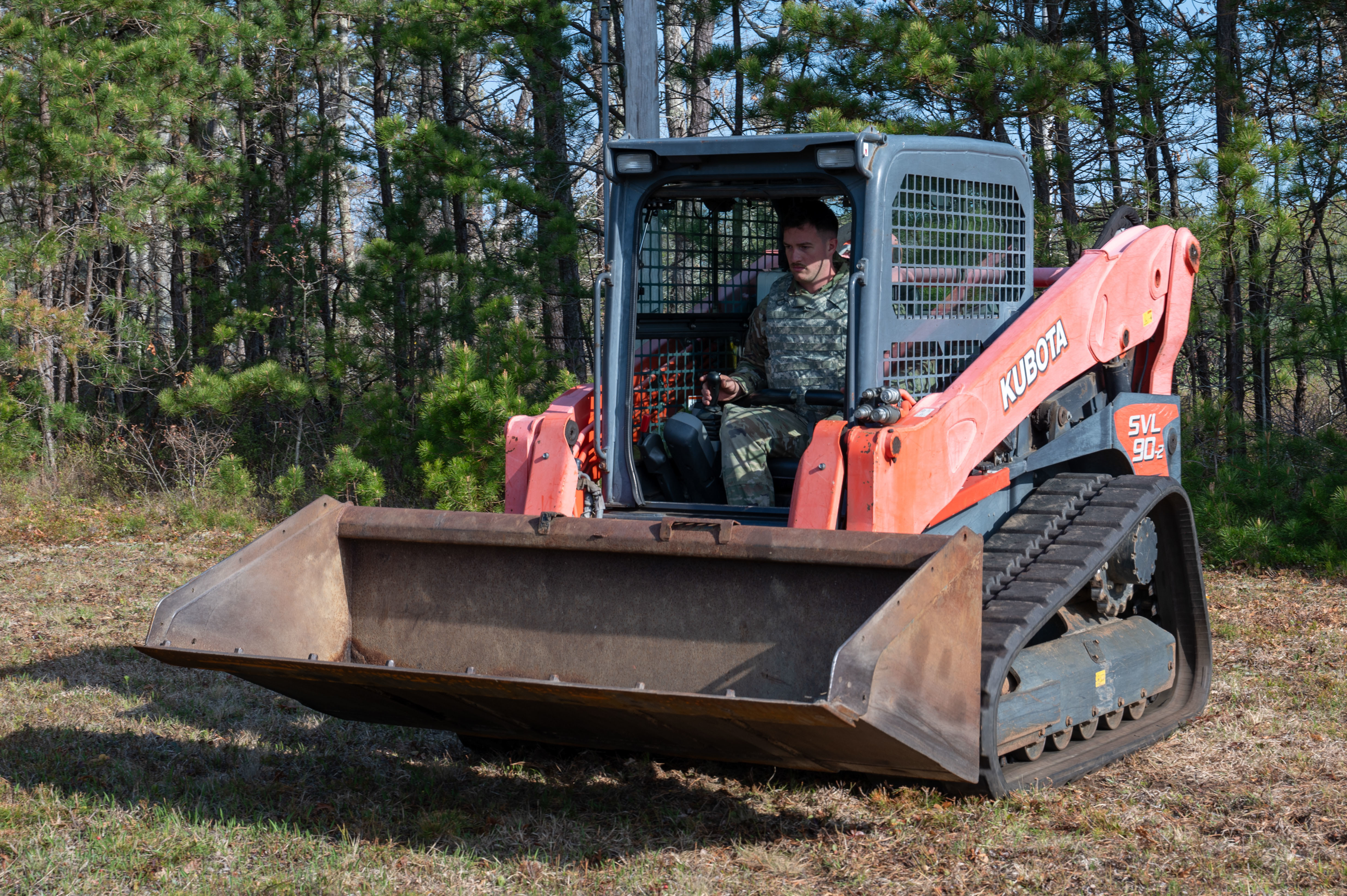 U.S. Air Force Staff Sgt. Trenton DeTerra, a pavements and construction equipment specialist with the 102nd Civil Engineer Squadron, drives a compact track loader on Otis Air National Guard Base, Massachusetts, May 3, 2025. As part of Exercise Iron Nomad, 102nd CES personnel trained on airfield damage repair, including crater and spall repair and continued runway maintenance. (Air National Guard photo by Senior Airman Julia Ahaesy)