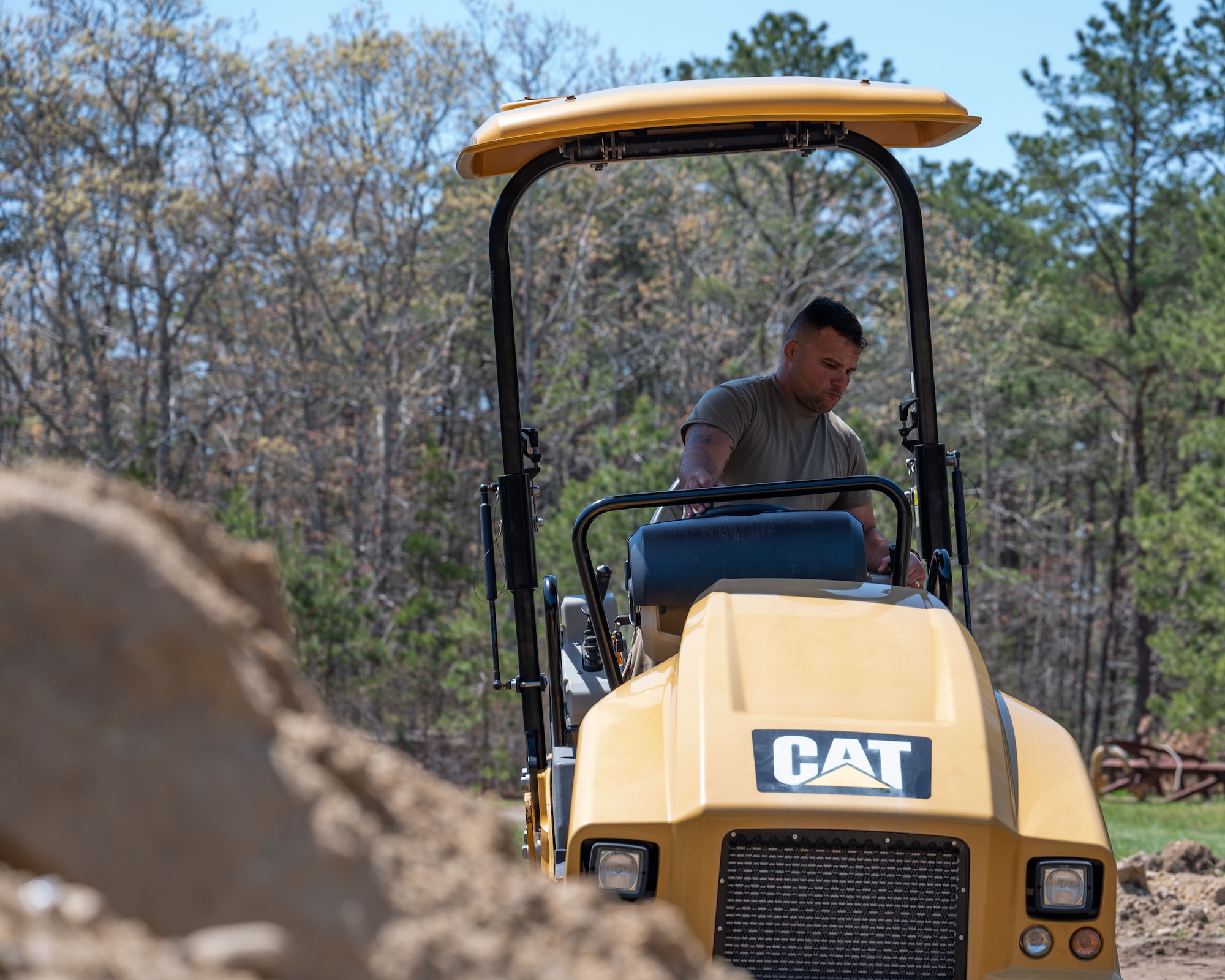 Airman drives a roller.