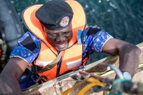 A Gambian Navy Sailor boards a merchant training vessel during a Senegalese led Visit, Board, Search, and Seizure (VBSS) training exercise at Obangame Express. Obangame Express is one of three regional maritime exercises led by U.S. Sixth Fleet as part of a comprehensive strategy to provide collaborative opportunities to African forces and international partners to address maritime security concerns.