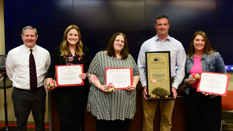 Craig Carrington (Left), U.S. Army Corps of Engineers Nashville District deputy for Project Management, presents the Hedgehog Award Trophy to Josh Frost, Regulatory Division chief, and certificates May 14, 2025, to (Left to Right) Cara Beverly, Vessica Ragon, and Mary Ann Brannan. The award recognizes the Regulatory Division Hurricane Helene Rapid Response Permitting Team for outstanding dedication and professionalism in processing more than 200 emergency permit applications following Hurricane Helene. Thomas Giordano, Aric Payne, Marian Rubin, Dani Walker, Eric Sinclair and Michael Bowling were not present but were also recognized. (USACE Photo by Lee Roberts)