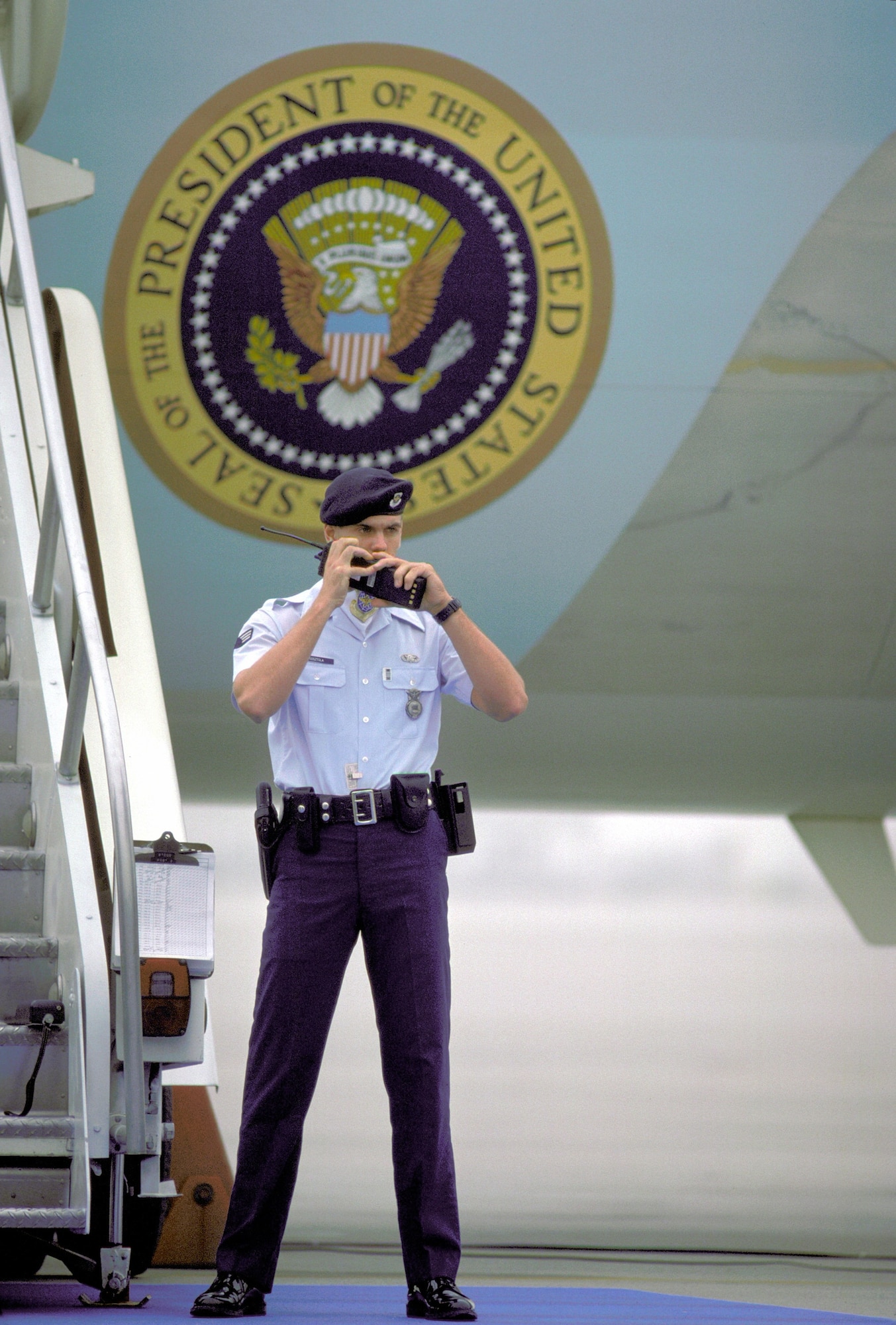 Senior Airman George Gosztola, 63rd Security Police Squadron, guards Air Force One during President Ronald Reagan tour of Andrews Air Force Base, Nov. 1, 1988.