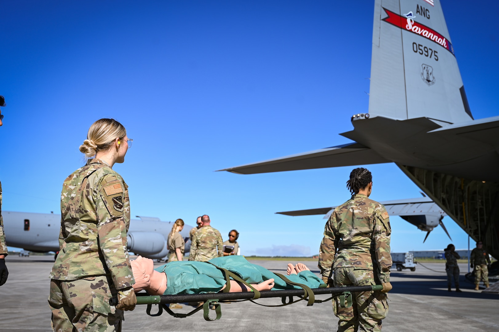 U.S. AIr National Guard medical Airmen load role players with simulated casualties for transport on a C-130J Super Hercules aircraft assigned to the Georgia Air National Guard's 165th Airlift Wing on the Air Dominance Center’s flight line in Savannah, Georgia, March 25, 2025.