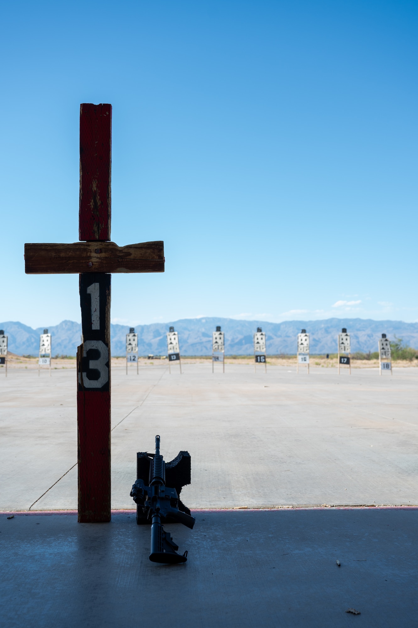 An M4 carbine rifle rests on the firing line