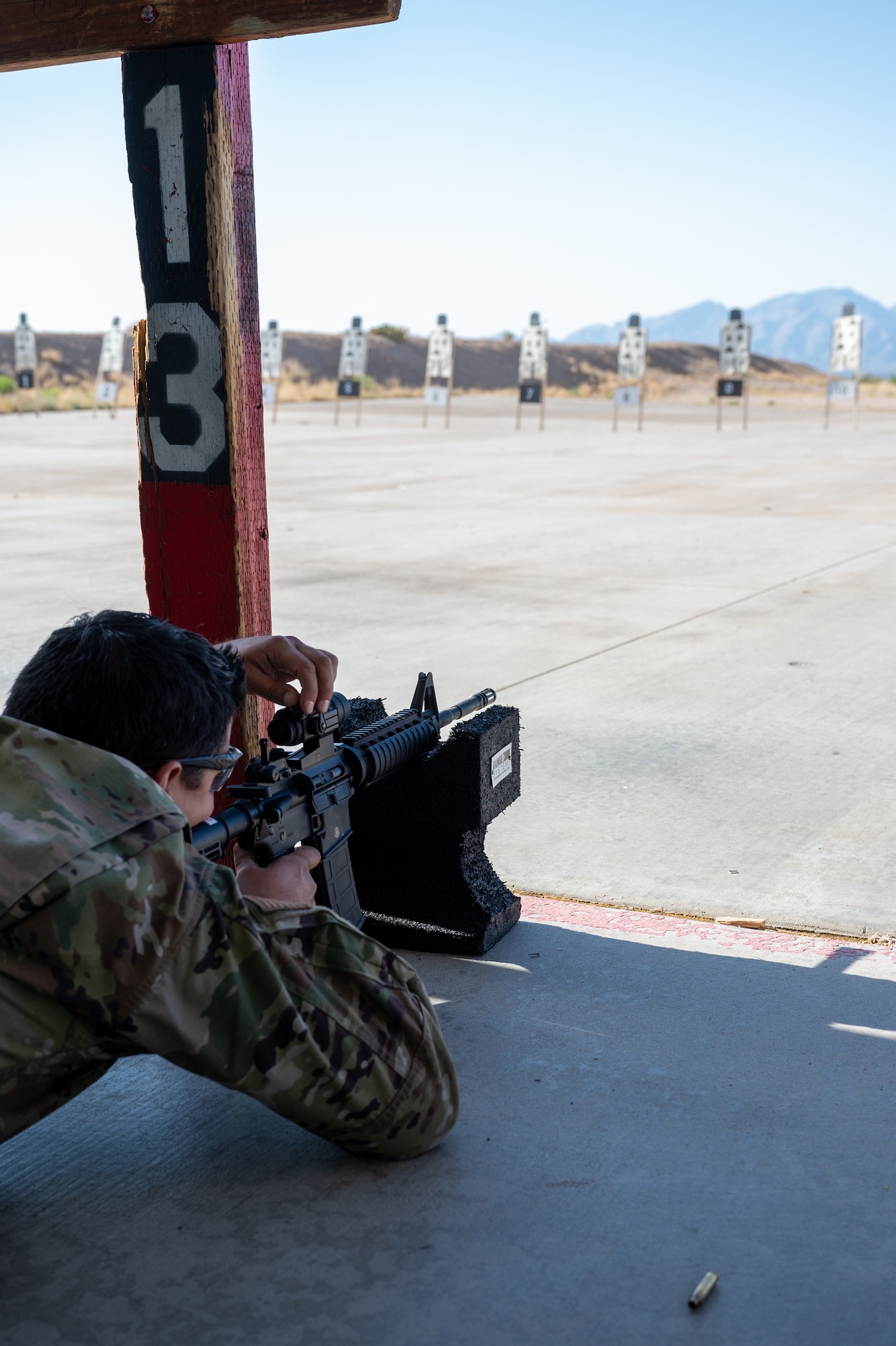 An Airman adjusts the sights on the M4 carbine rifle
