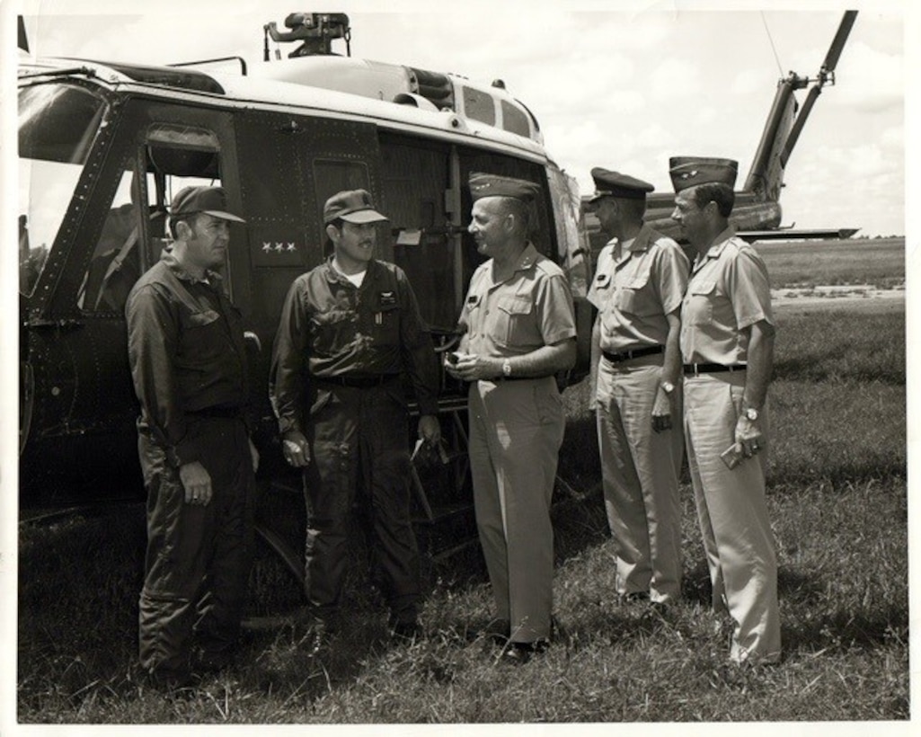 J.B. West (left) briefs Lt. Gen. Frederick J. Clarke (third from left), and Chief of Engineers from 1969 to 1973, prior to an aerial inspection of the Tennessee Colony Project in 1971. West simultaneously worked for the Corps of Engineers and served in the Army Reserve as the commander of an aviation unit. West routinely combined his two careers to include flying the length of the Trinity River from Fort Worth to the Galveston Bay for a preliminary design to make the river navigable up to Fort Worth.