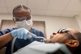 U.S. Navy Hospital Corpsman 3rd Class Niyona Gibbs, a dental technician with 2nd Dental Battalion, 2nd Marine Logistics Group, and a native of Bayboro, North Carolina, uses a saliva aspirator on a Sailor mouth at Marine Corps Base Camp Lejeune, North Carolina, May 12, 2025. Gibbs was selected as the 2nd MLG Warrior of the Week by her leadership for her proficiency, maturity, and dedication to her job as a dental technician.  Her impact during exercise Joint Viking was remarkable where she assisted in the care of 200 patients and provided 75 hours of medical coverage during six training evolutions for the exercise. Each week, 2nd MLG recognizes one outstanding Marine or Sailor that goes above and beyond in their duties and embodies the qualities of an outstanding service member. (U.S. Marine Corps photo by Sgt. Alfonso Livrieri)