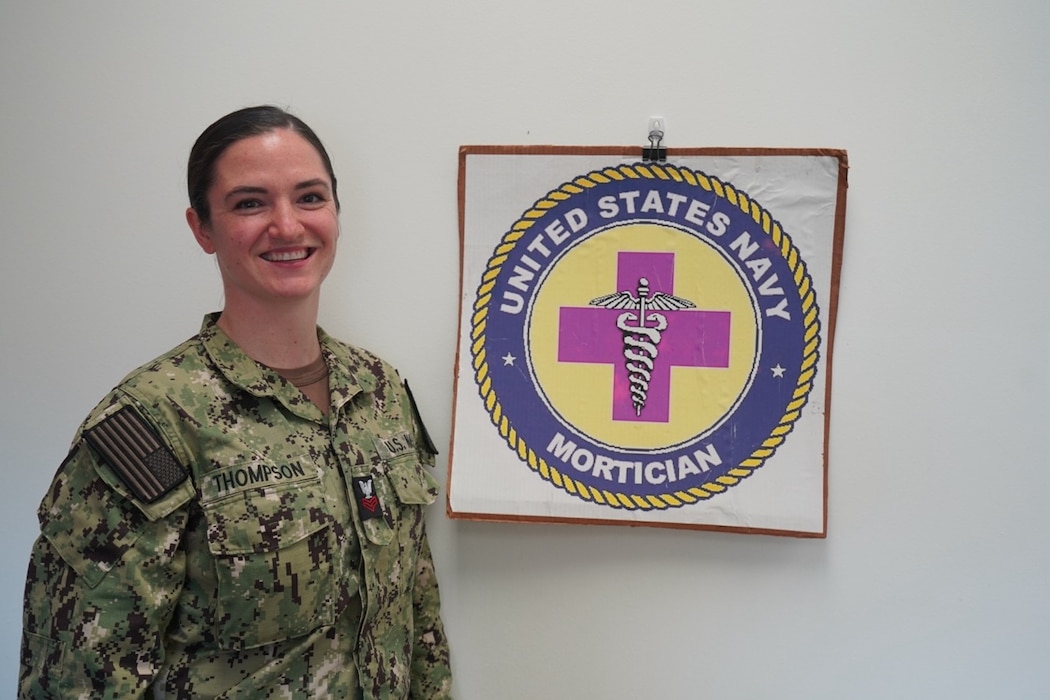 250501-N-FT324-8093. Hospital Corpsman First Class (HM1) Julianne Thompson, stationed at Naval Hospital Rota, gives a tour of the Navy mortuary facilities in Rota, Spain, highlighting the critical responsibilities and operational support her role provides in ensuring dignified and respectful care. (U.S. Navy Photo by Lt. Cmdr. Alicia Sacks)