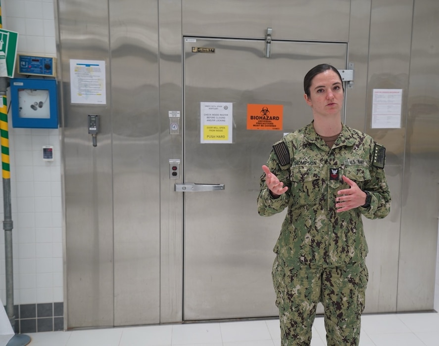 250501-N-FT324-5269. Hospital Corpsman First Class (HM1) Julianne Thompson, stationed at Naval Hospital Rota, gives a tour of the Navy mortuary facilities in Rota, Spain, highlighting the critical responsibilities and operational support her role provides in ensuring dignified and respectful care. (U.S. Navy Photo by Lt. Cmdr. Alicia Sacks)