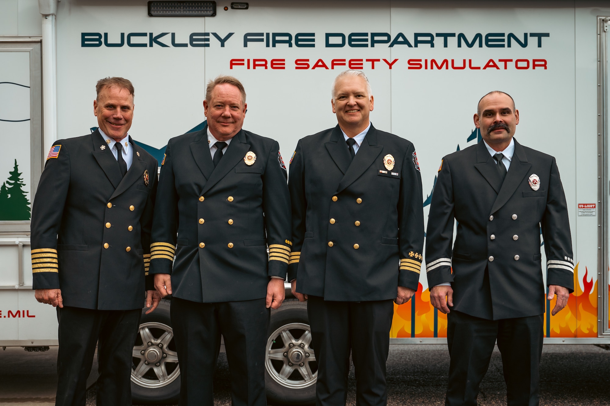 Four men stand for group photo