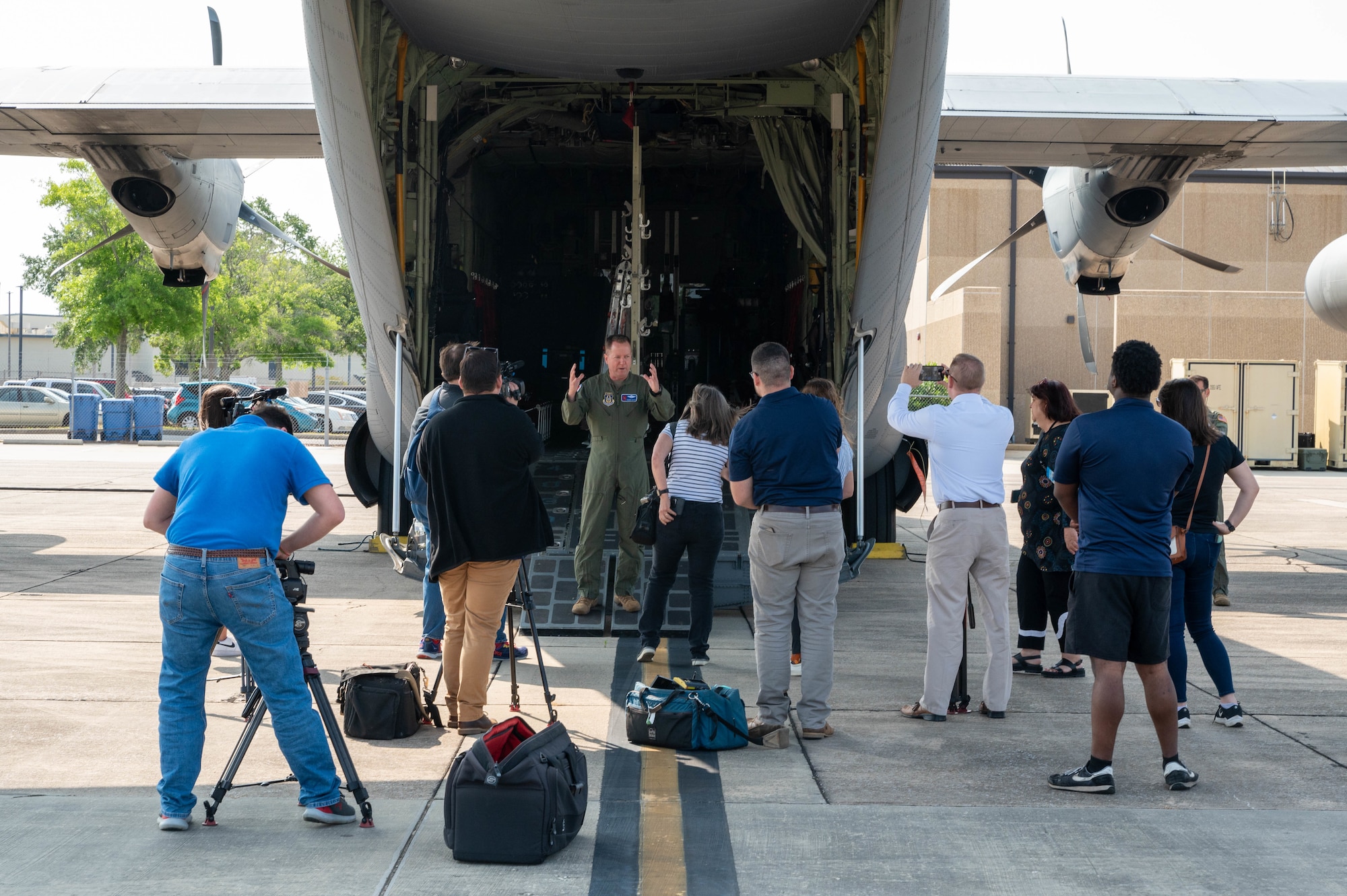 Airman briefing media on flightline