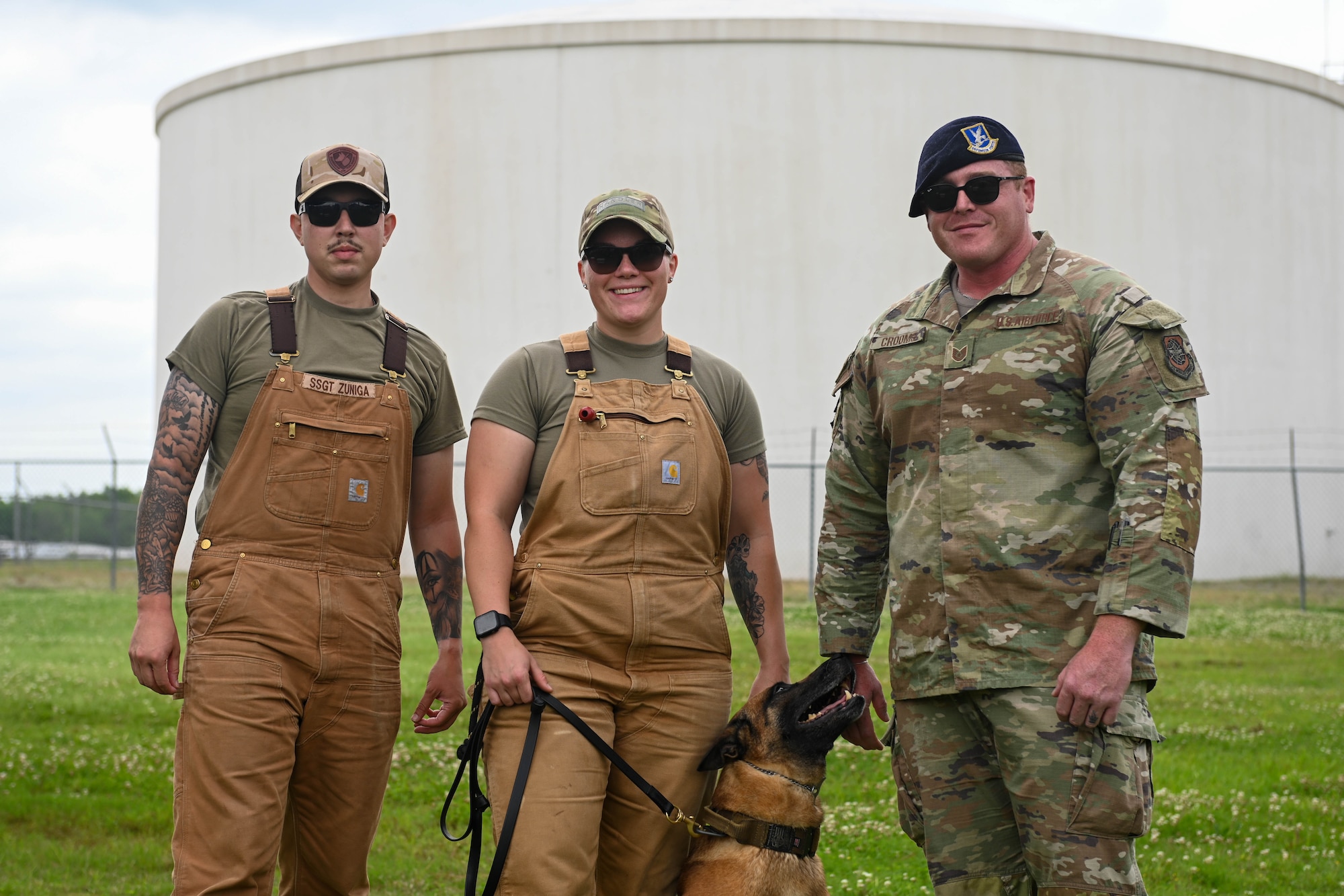 K-9 unit airmen pose for photo with K-9.