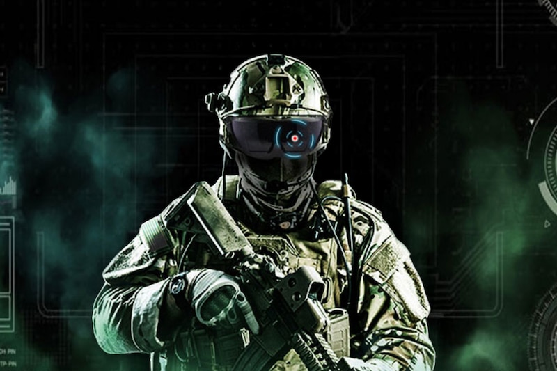 A soldier wearing a futuristic combat uniform and holding a weapon looks forward.