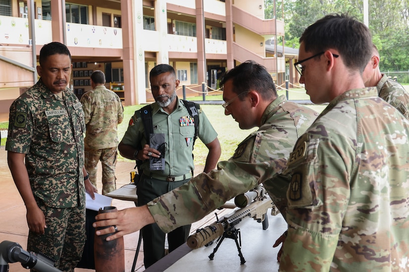 Malaysian Army Warrant Officer 1 Shahamrie Bin Abdullah, Malaysian Armed Forces sergeant major, and Maldives National Defense Force Command Sgt. Maj. Nasrulla Waseem, command sergeant major of the Maldives National Defense Force, receive a briefing about U.S. Army Explosive Ordnance Disposal tactics during a Senior Enlisted Leaders Forum on Schofield Barracks, Hawaii, May 13, 2025 as part of the Land Forces Pacific (LANPAC) Symposium. LANPAC Symposium and Exposition is the premier forum for land power discussions in the Indo-Pacific region. Hosted by the Association of the United States Army and supported by U.S. Army Pacific, LANPAC 2025 brings together representatives from more than 30 Indo-Pacific nations, including a dozen Chiefs of Armies, to address critical security challenges. (U.S. Army Photo by Spc. Wyatt Moore , 28th Public Affairs Detachment)