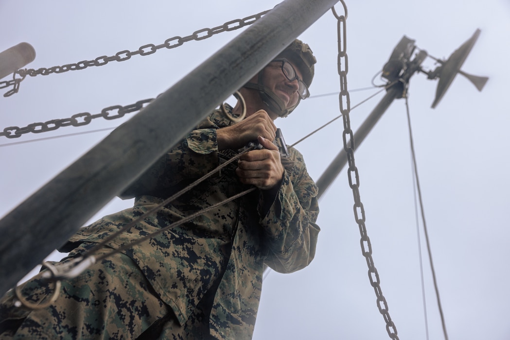 U.S. Marine Corps Lance Cpl. David Hodgkins tightens a rope to set up a Long-Range Radio System during Exercise Triad Thunder as part of Kaiju Rain on Camp Hansen, Okinawa, Japan, May 5, 2025.