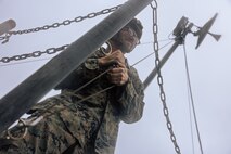 U.S. Marine Corps Lance Cpl. David Hodgkins tightens a rope to set up a Long-Range Radio System during Exercise Triad Thunder as part of Kaiju Rain on Camp Hansen, Okinawa, Japan, May 5, 2025.