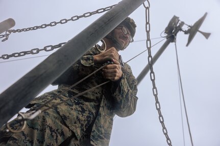 U.S. Marine Corps Lance Cpl. David Hodgkins tightens a rope to set up a Long-Range Radio System during Exercise Triad Thunder as part of Kaiju Rain on Camp Hansen, Okinawa, Japan, May 5, 2025.