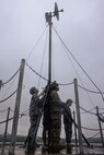 U.S. Marines with A Company and B Company, 7th Communication Battalion, III Marine Expeditionary Force Information Group, set up a Long-Range Radio System during Exercise Triad Thunder as part of Kaiju Rain on Camp Hansen, Okinawa, Japan, May 5, 2025.